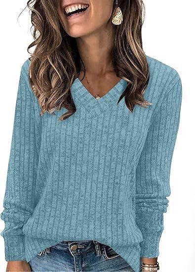 Ribbed V-neck long-sleeve top in light teal, worn with jeans