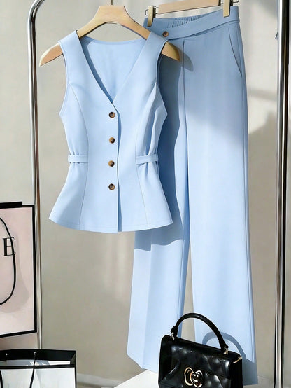 Open sleeveless button-front vest top and wide-leg pants set in light blue, laid out on a hanger