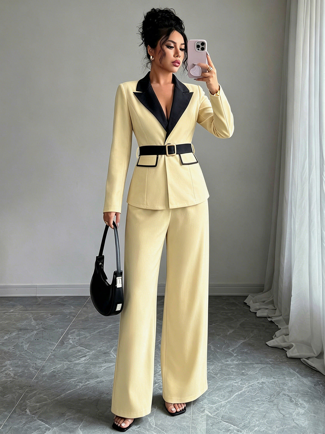 Pale yellow long-sleeve belted blazer with navy lapel and matching wide-leg pants