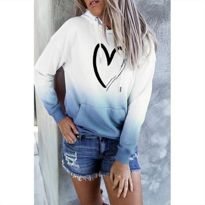 White hoodie with a black heart print and blue gradient hem
