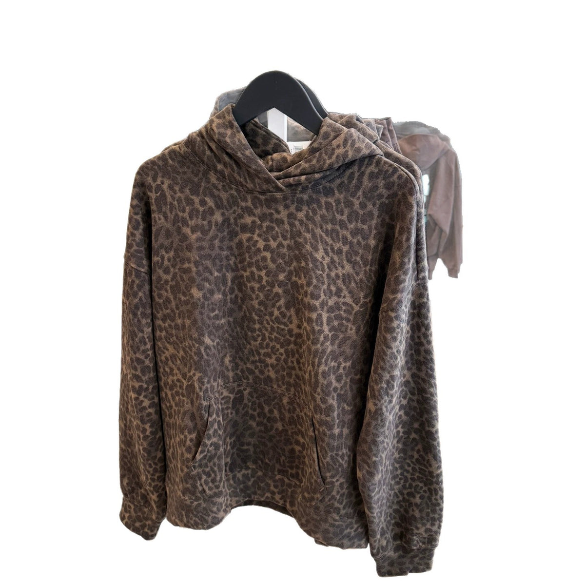 Leopard print pullover hoodie hanging on a hanger