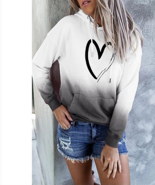 White hoodie with a black heart print and gray gradient hem