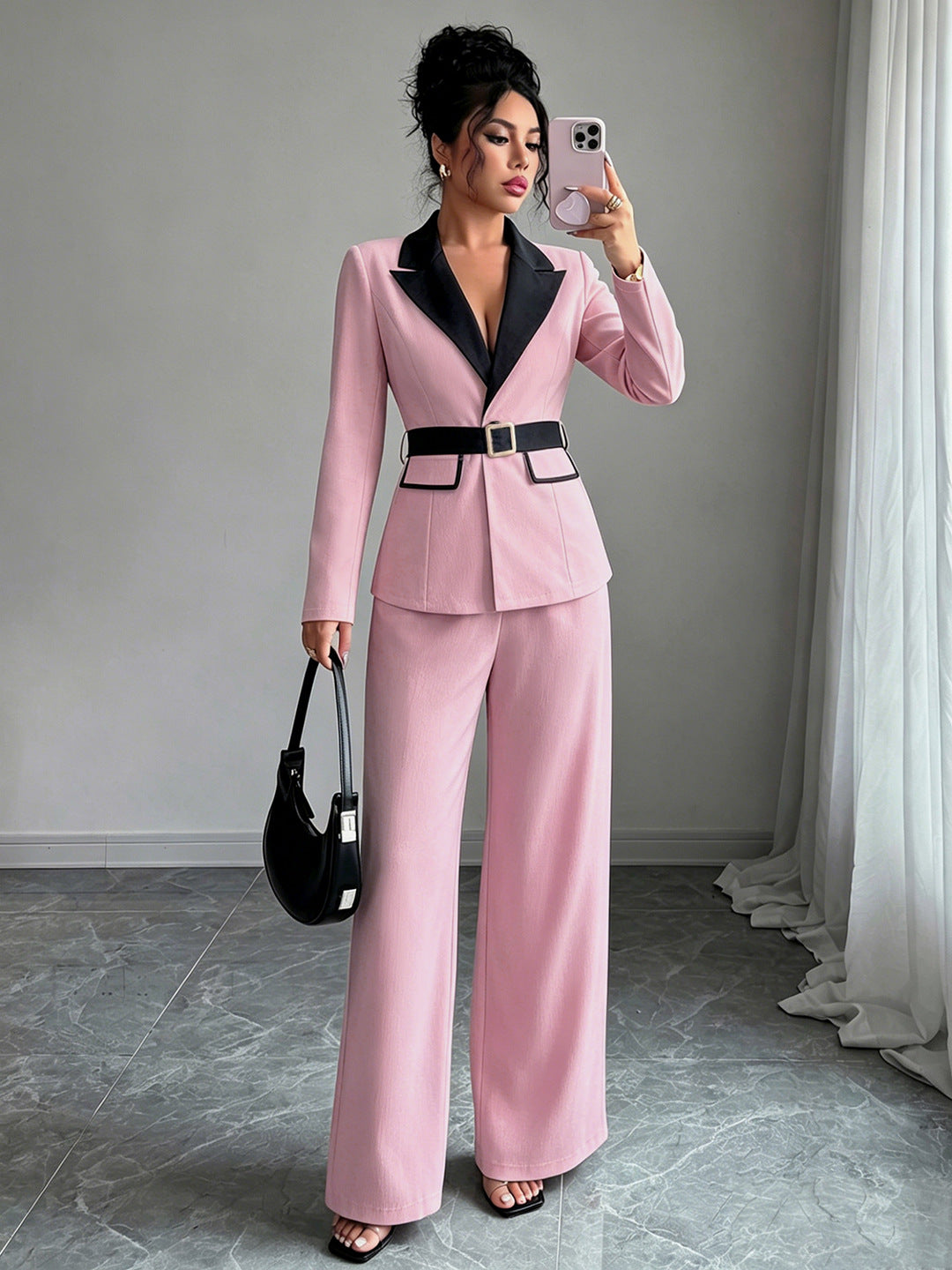 Pink long-sleeve belted blazer with navy lapel and matching wide-leg pants