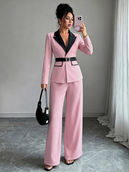 Pink long-sleeve belted blazer with navy lapel and matching wide-leg pants
