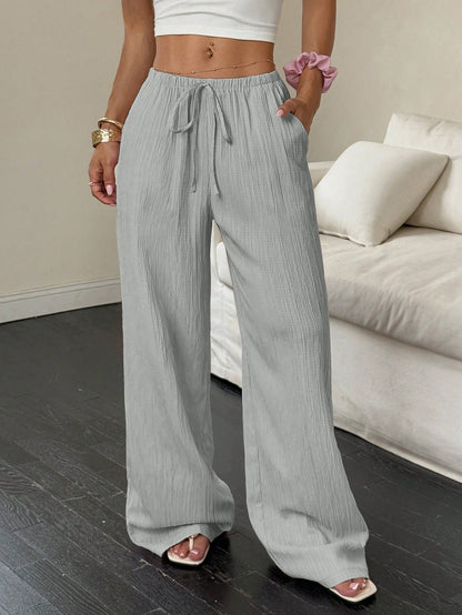 Drawstring wide-leg pants with a textured finish in light gray, front view