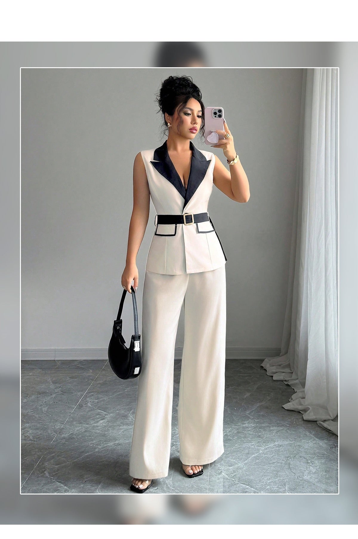 Ivory sleeveless belted blazer set with navy lapel, framed front view