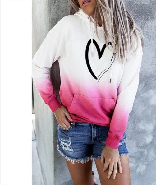 White hoodie with a black heart print and hot pink gradient hem