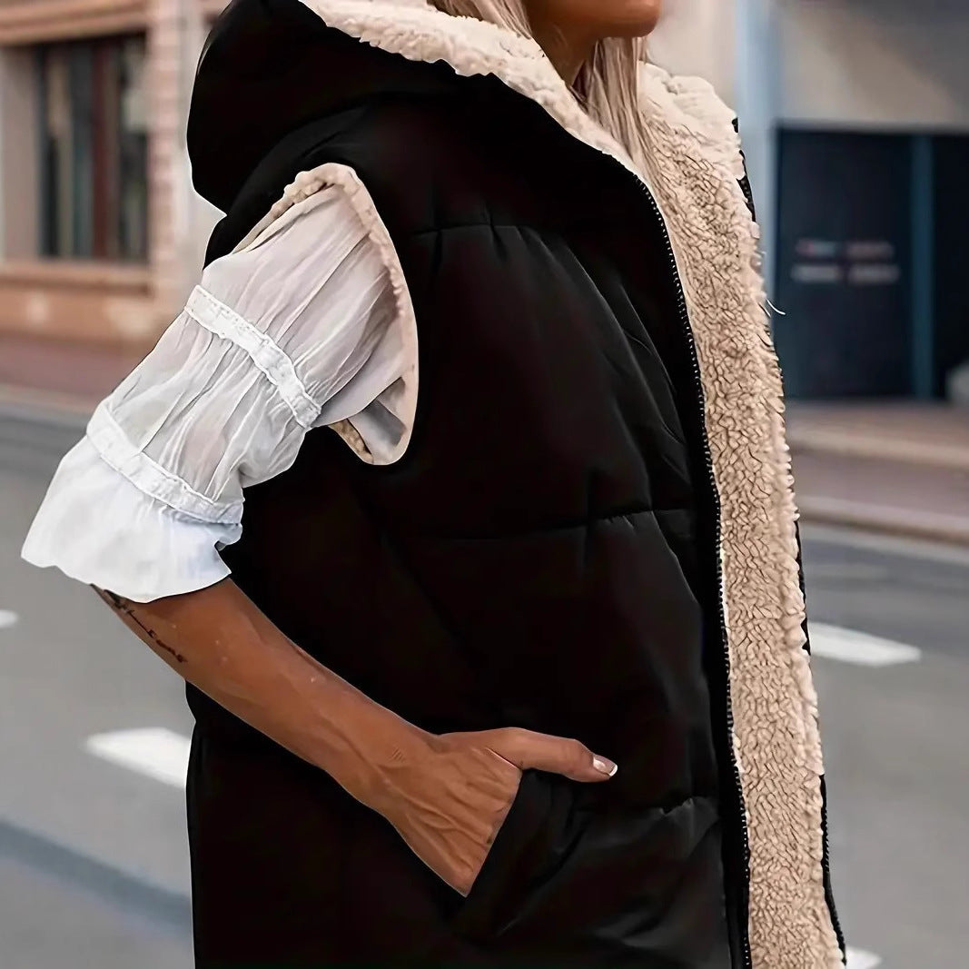 Black quilted hooded vest close-up showing the pocket and sherpa lining