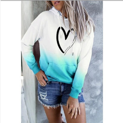White hoodie with a black heart print and aqua gradient hem