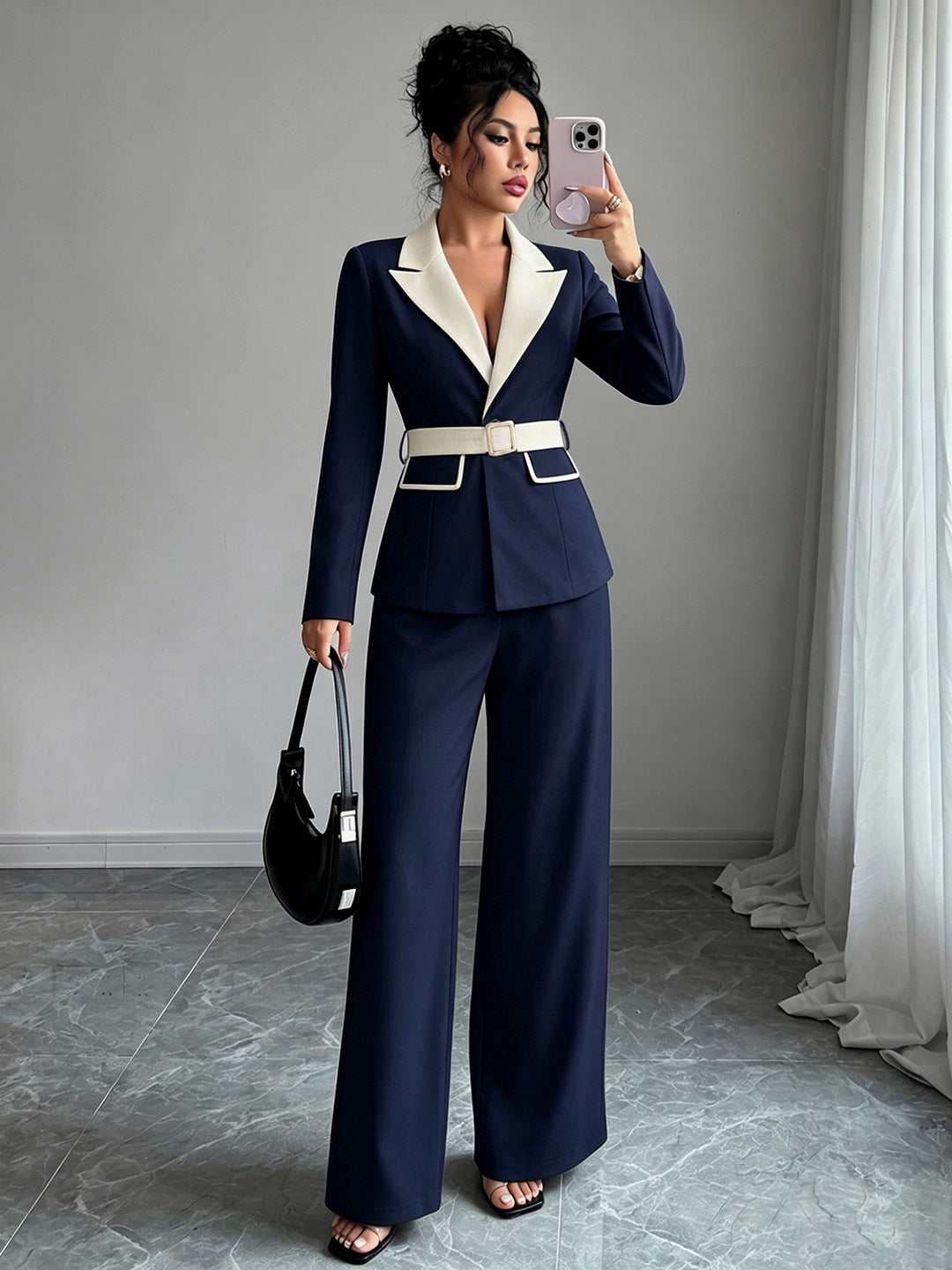 Navy long-sleeve belted blazer with white lapel and matching wide-leg pants