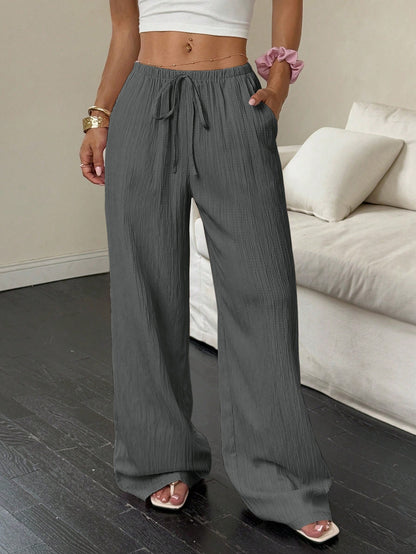 Drawstring wide-leg pants with a textured finish in charcoal gray, front view
