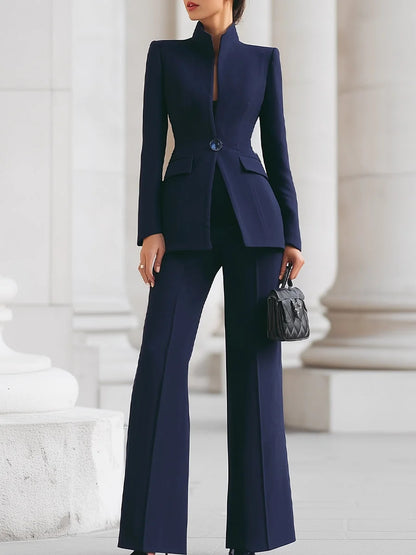Navy stand-collar fitted blazer and flare pants set styled with a black handbag