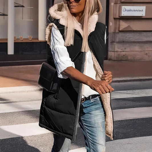 Black long quilted hooded vest with sherpa lining, worn with jeans