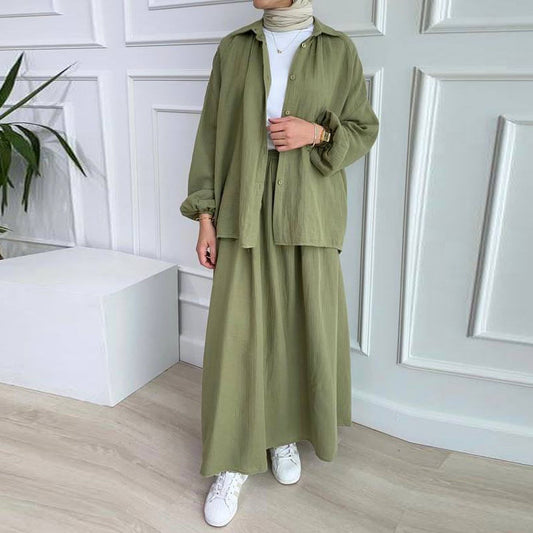 Olive green loose-fit shirt and long skirt set, front view worn open over a white top