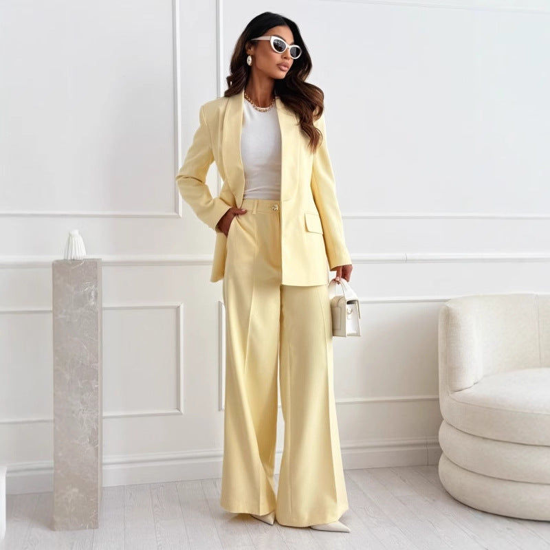 Butter yellow blazer and wide-leg pants set styled with a small handbag