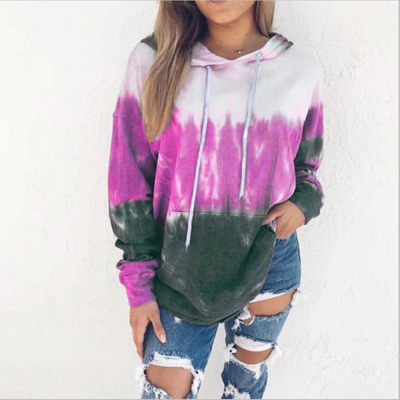 Gradient tie-dye hooded pullover in magenta and dark green, worn with distressed jeans