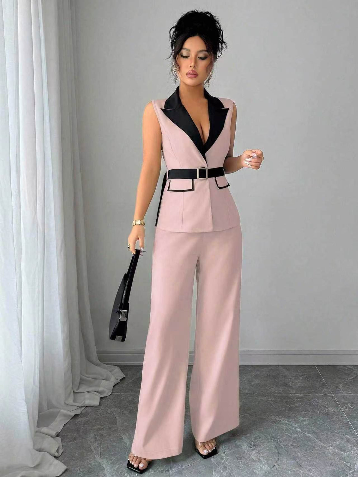 Pink sleeveless belted blazer top with navy lapel and matching wide-leg pants, front view