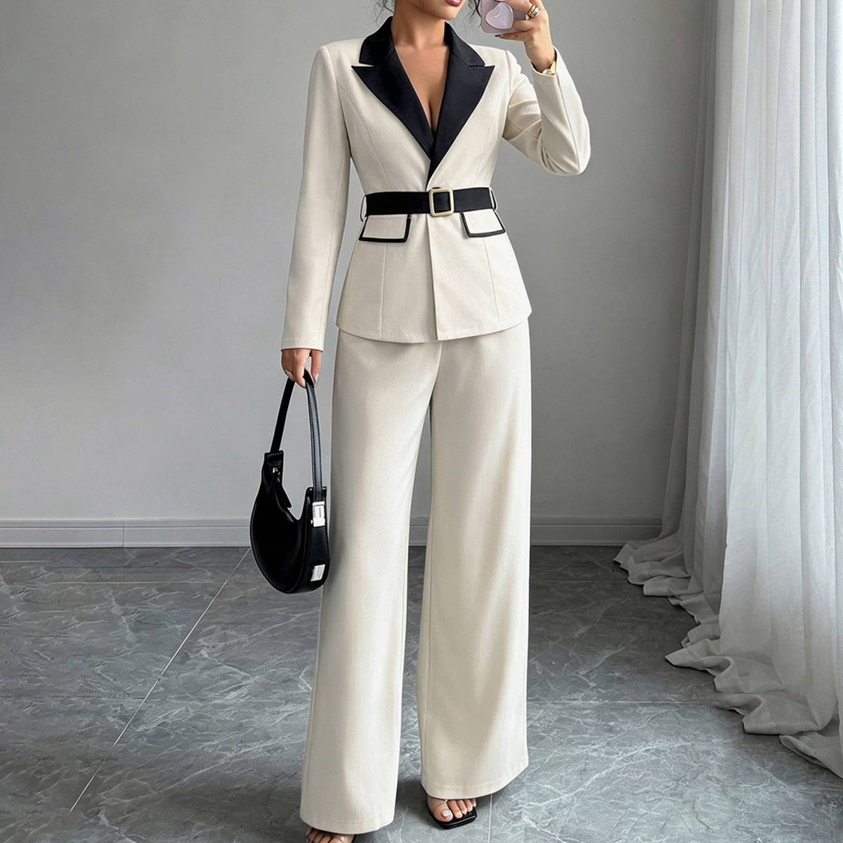 Ivory long-sleeve belted blazer with navy lapel and wide-leg pants