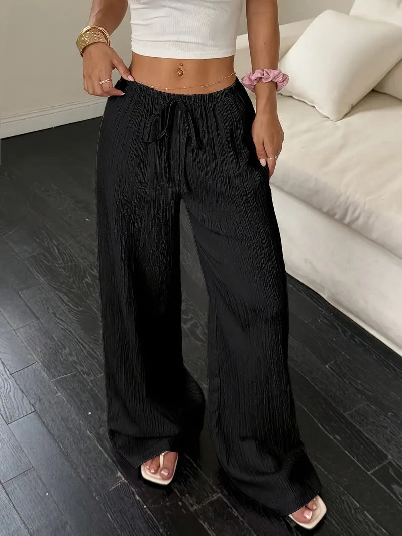Drawstring wide-leg pants with a textured finish in black, front view