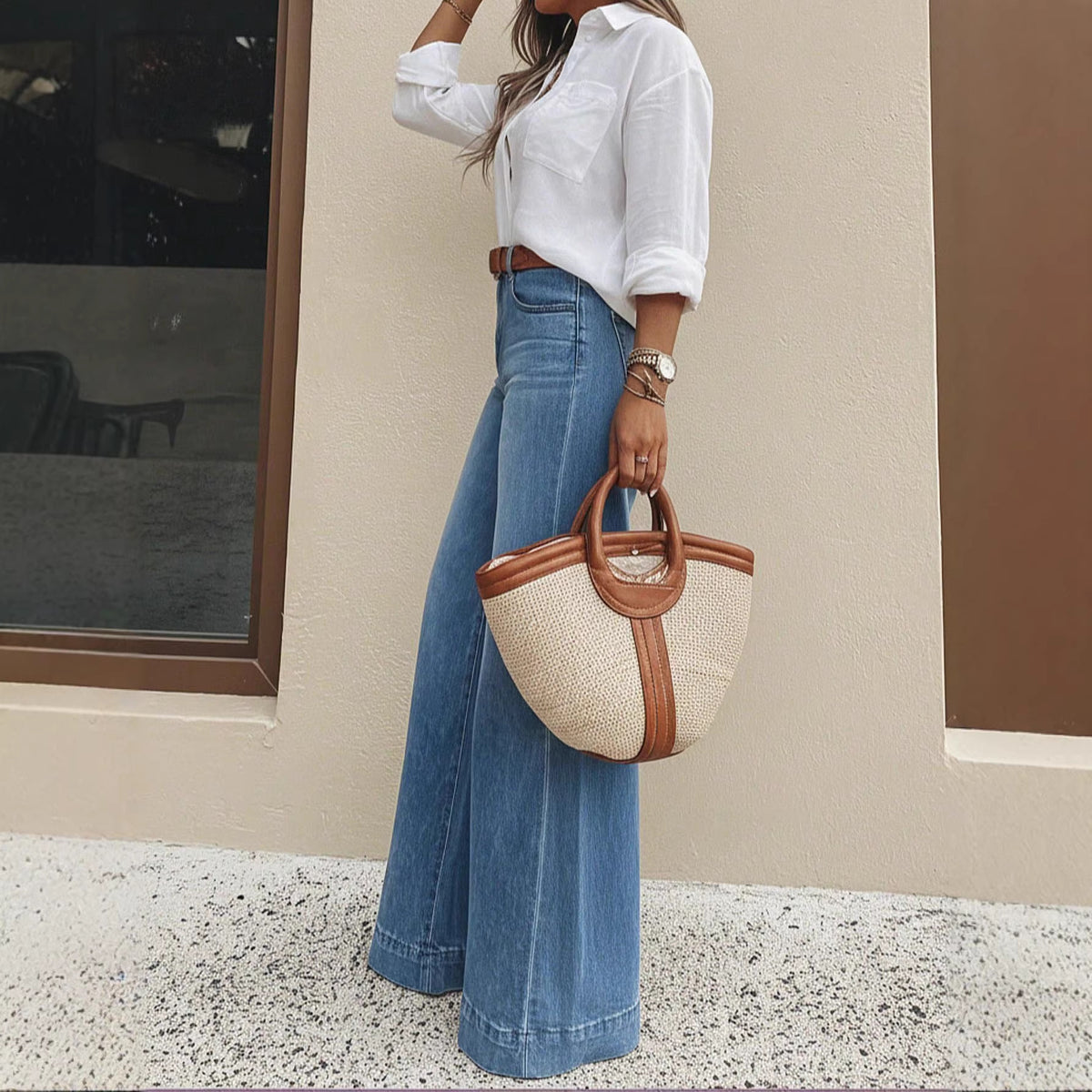 Light blue washed high-waist wide-leg jeans, side view with a straw tote