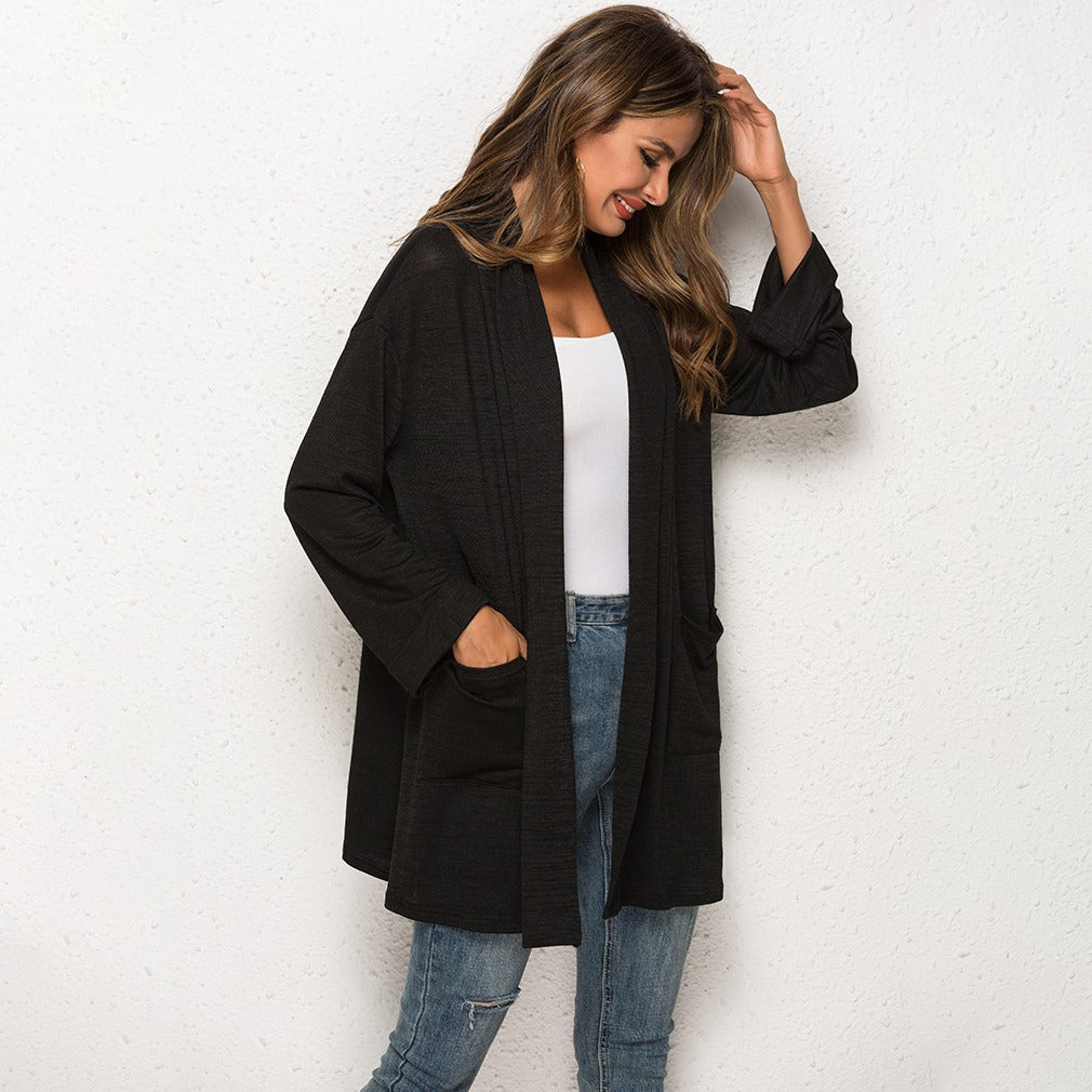 Black longline cardigan with patch pockets, side view
