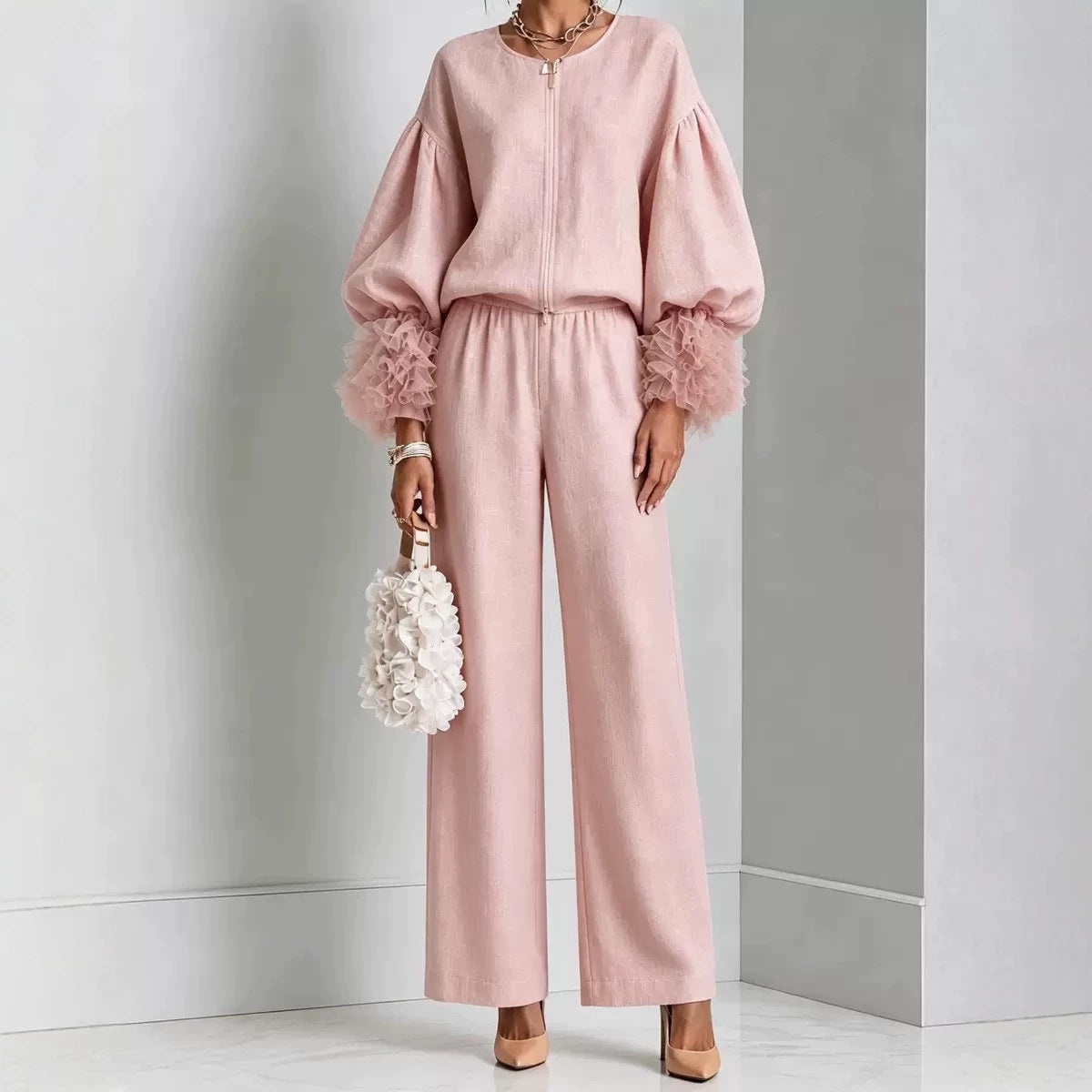 Blush pink zip-front top with balloon sleeves and feather-trim cuffs with matching wide-leg pants