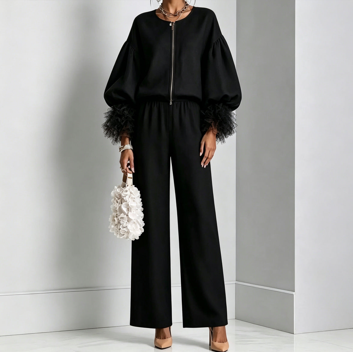 Black zip-front balloon sleeve top with feather-trim cuffs and wide-leg pants