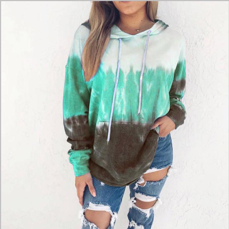 Gradient tie-dye hooded pullover in mint green and brown, worn with distressed jeans