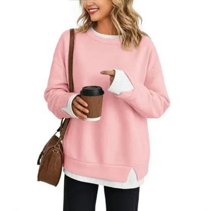 Double-layer crewneck sweater in light pink with white layered cuffs and hem, front view