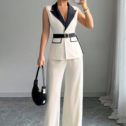 Ivory sleeveless belted blazer top with navy lapel and wide-leg pants, styled with a black handbag